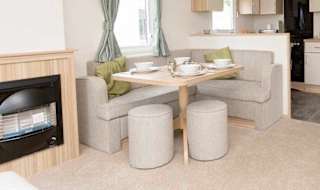 The living and dining area of our bright and spacious comfort static caravan. The perfect way to stay. image