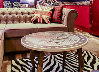 The lounge in our Rockstar holiday home. There’s a spacious kitchen, a large TV and sofa, and a theme of red, white, and blue Great British colours. image