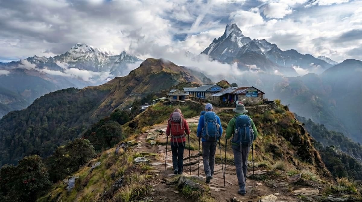 Trekkers approaching Mardi Himal High Camp with Machhapuchhre and Annapurna mountains in the background