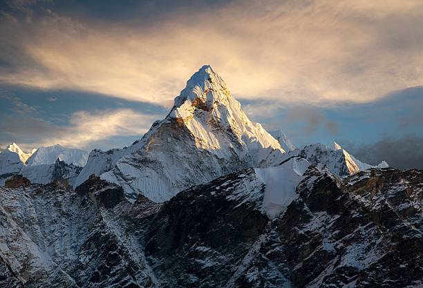 Hiker in the Himalayas at sunrise