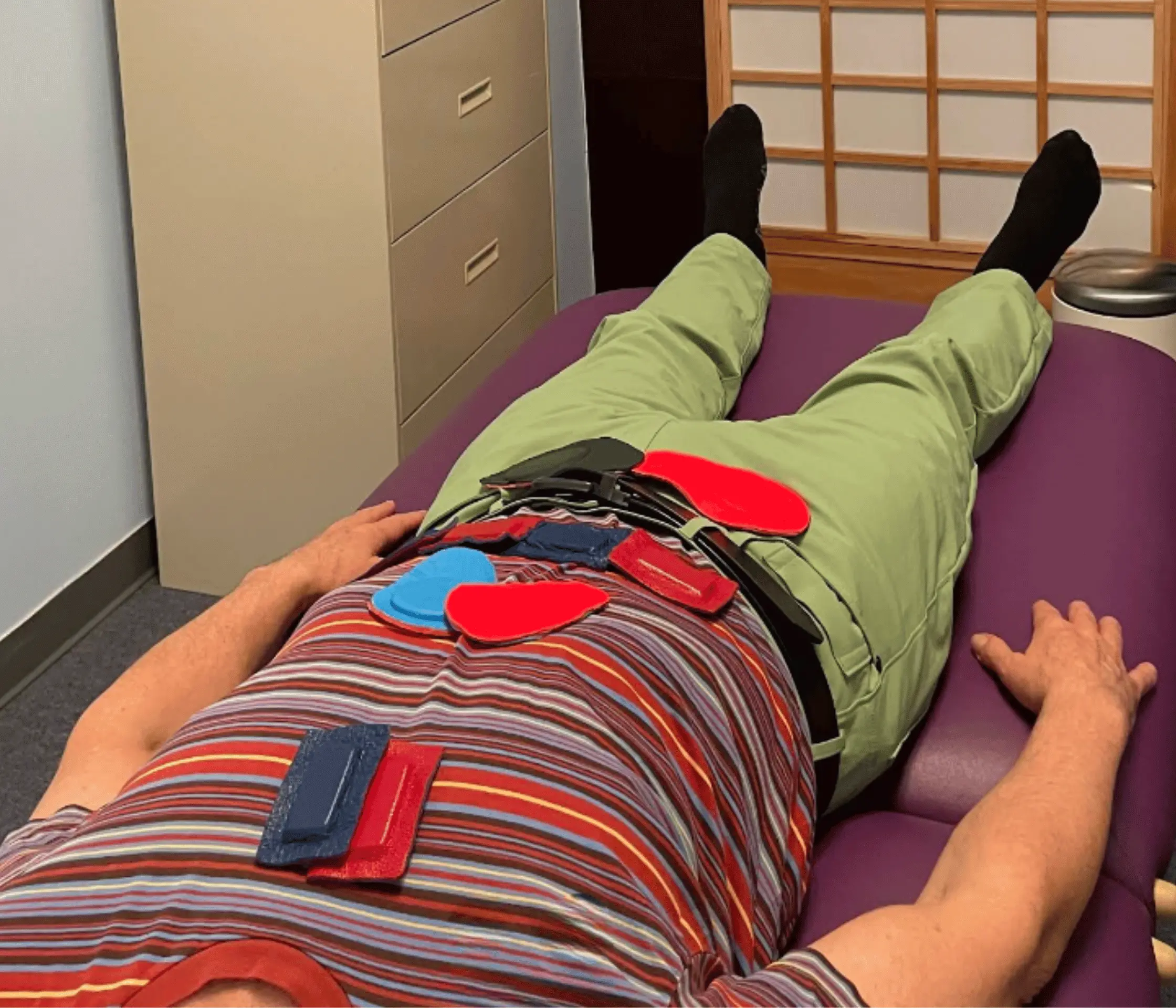 Biomagnetic Pair Therapy treatment — Dmitriy Kovarskiy, LMT applying magnets to patient in Manhattan