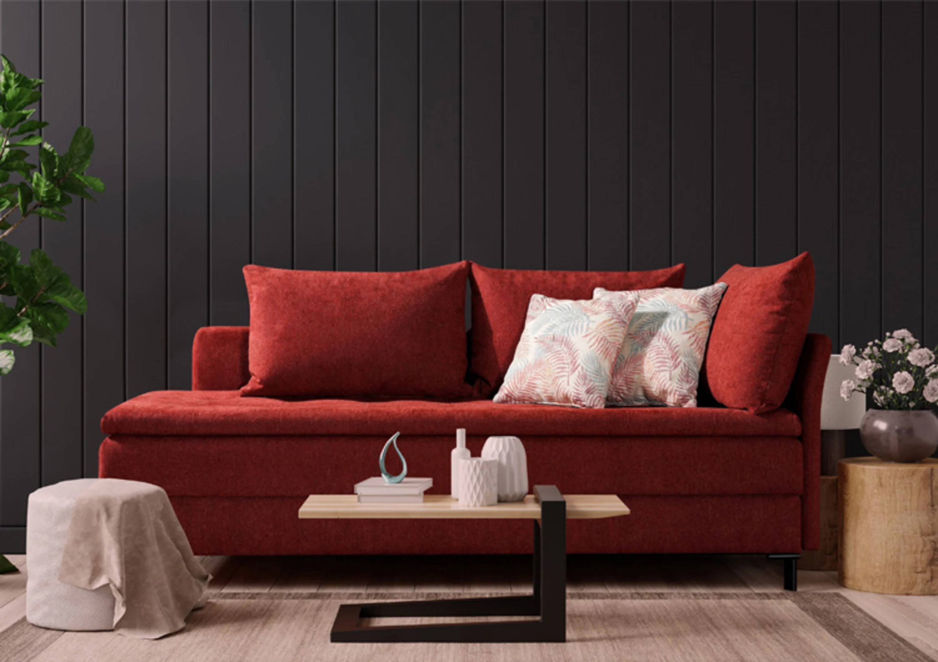 Man sieht eine rotes Schlafsofa. Es ist mit mehren großen Rücken und Zierkissen ausgestattet