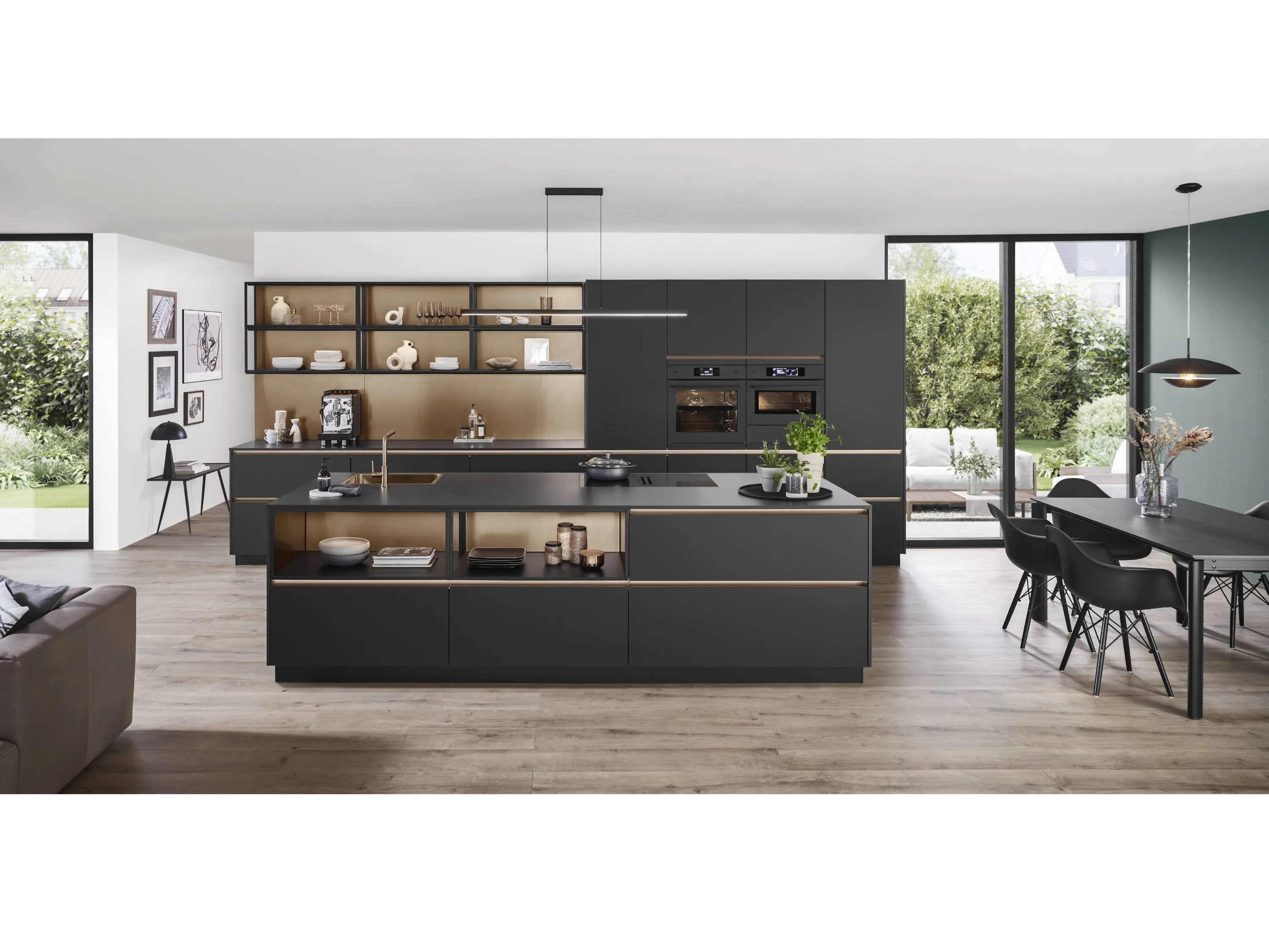 Grosse schwarze Küche mit Kochinsel mit integrierter Spüle und beleuchteter Griffleiste