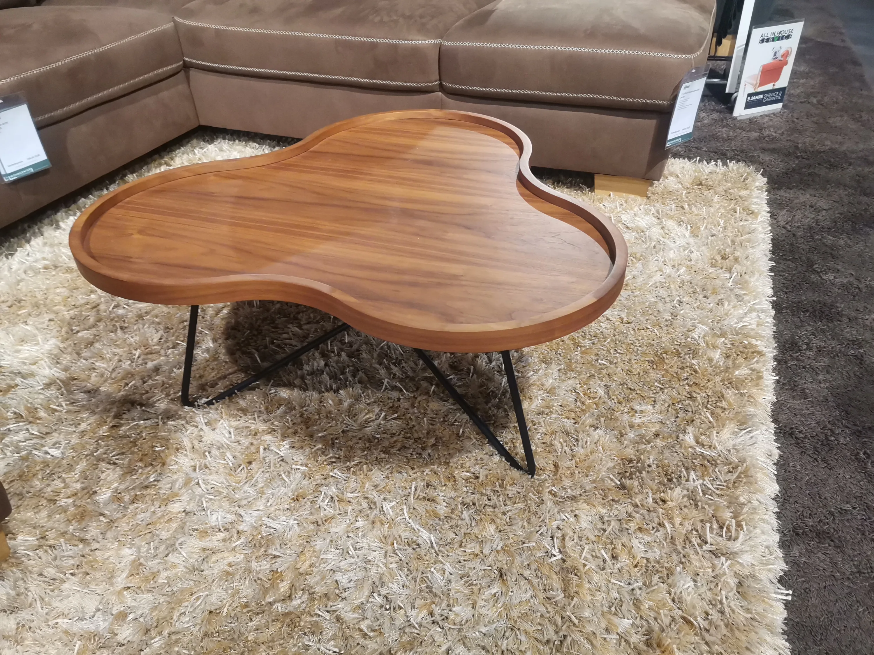 Hölzerner Couchtisch mit schwarzen Beinen und einer Holzplatte