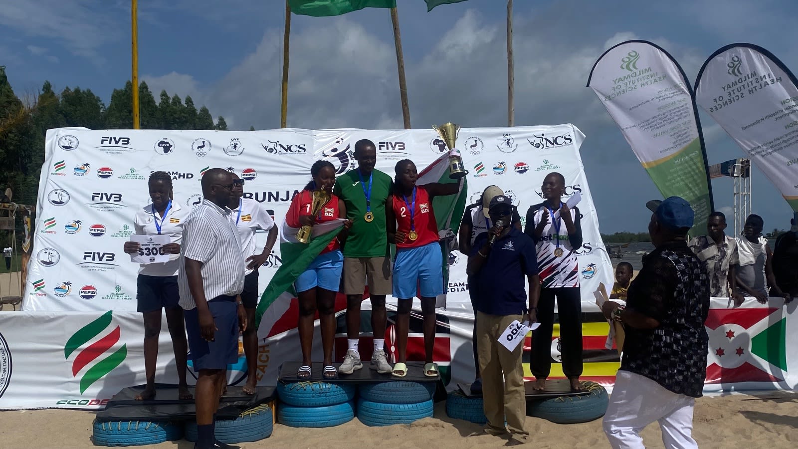 Burundi’s players pose with their medals and trophies after dominating the men’s and women’s categories.