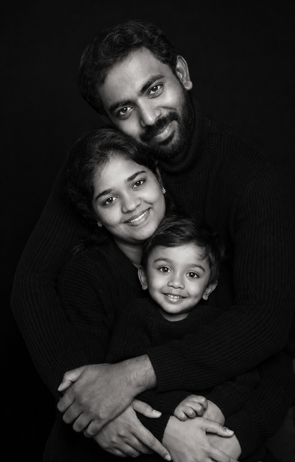 loving-indian-family-hug-studio-portrait.png