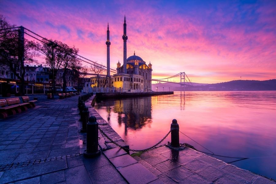 view of ortakoy mosque and the sea in istanbul in purple haze