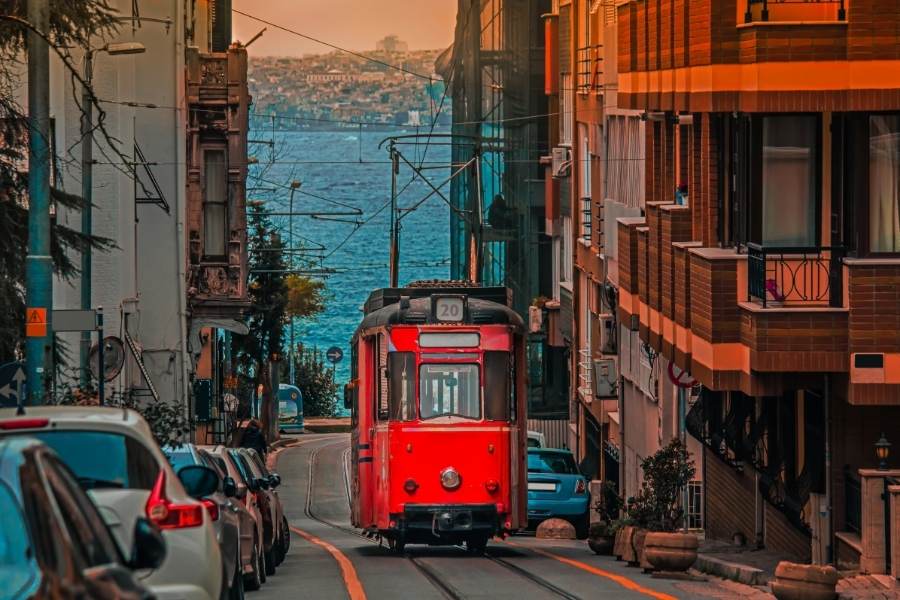 red tram in bahariye kadikoy istanbul with sea visible in the background