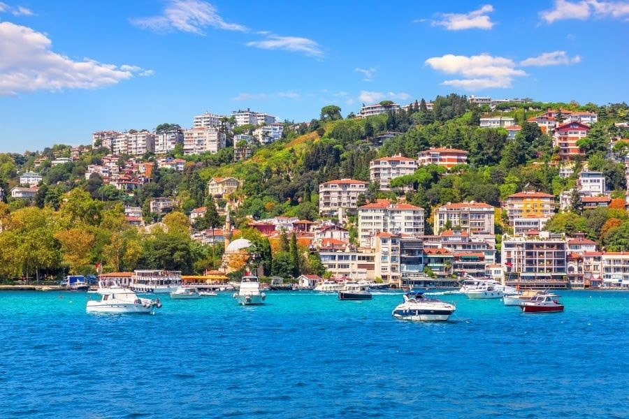 coastal view of bebek istanbul from the sea with boats trees and buildings