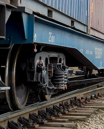 The cars of a freight train stretching into the distance