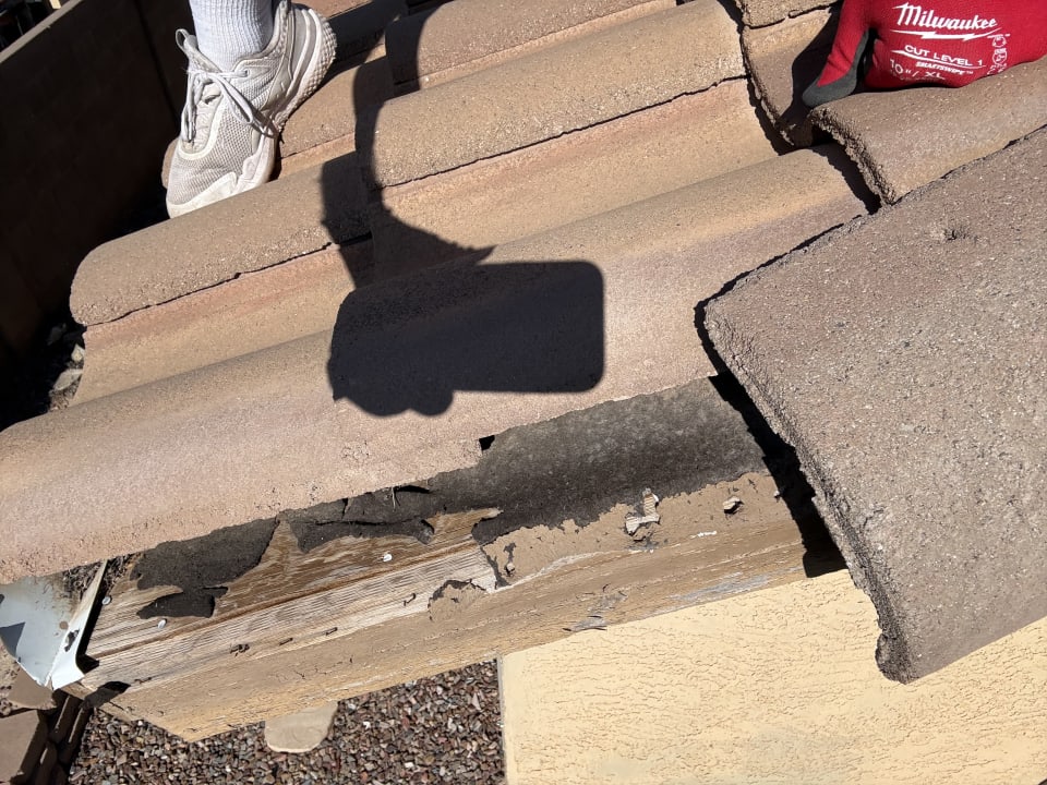 Missing tile and exposed deck at the rake edge of a Scottsdale roof