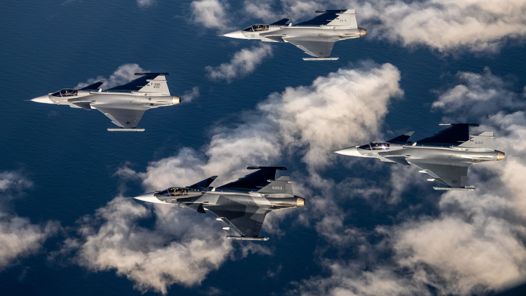 A four ship formation of Gripen E jet fighters for both the Swedish and Brazilian Air Force.