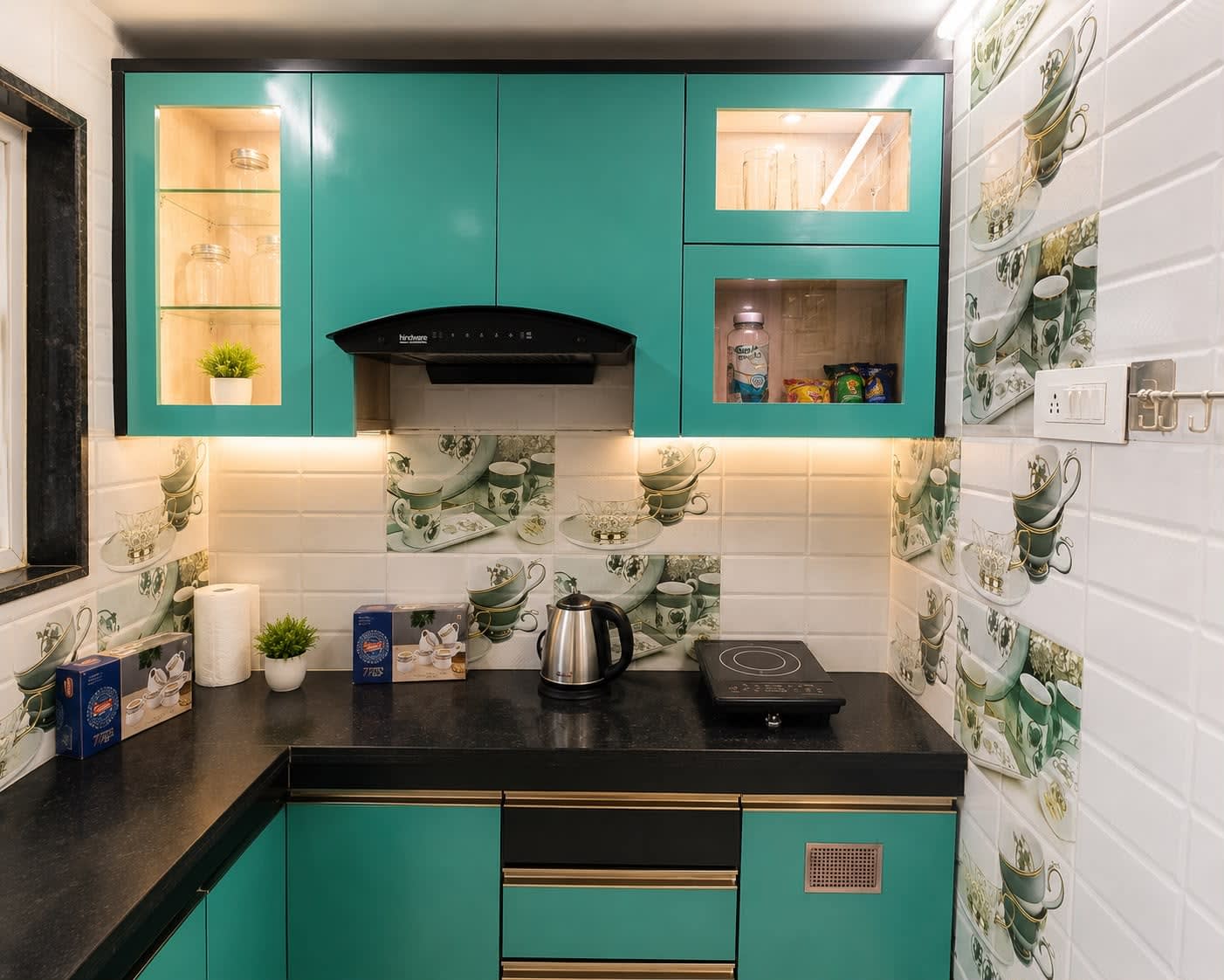 Modular Kitchen — Premium teal & black cabinetry, Hindware chimney hood, induction stove, electric kettle, glassware showcase