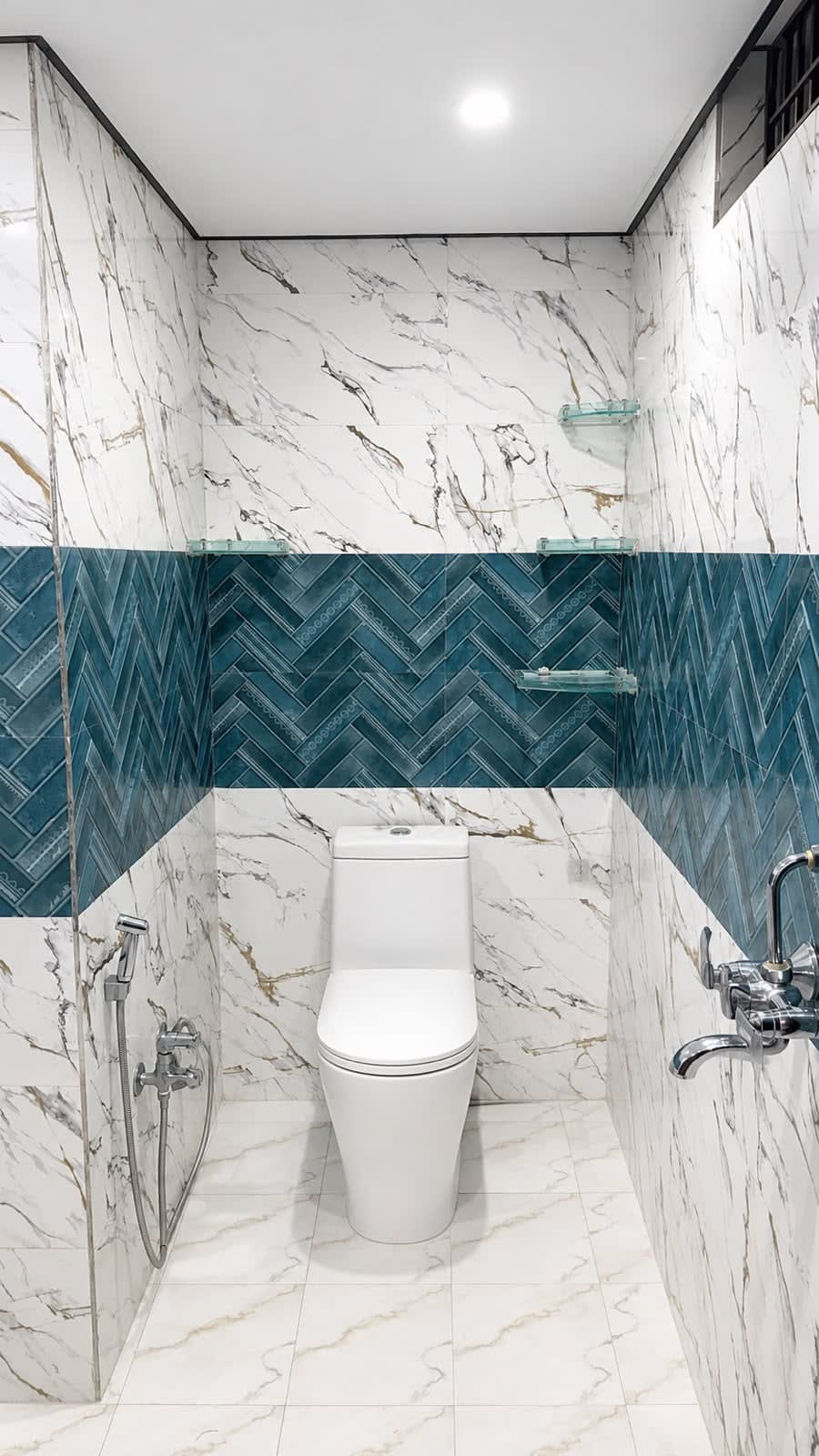 Designer Bathroom — Marble wall tiles with blue herringbone chevron feature wall, western commode, health faucet