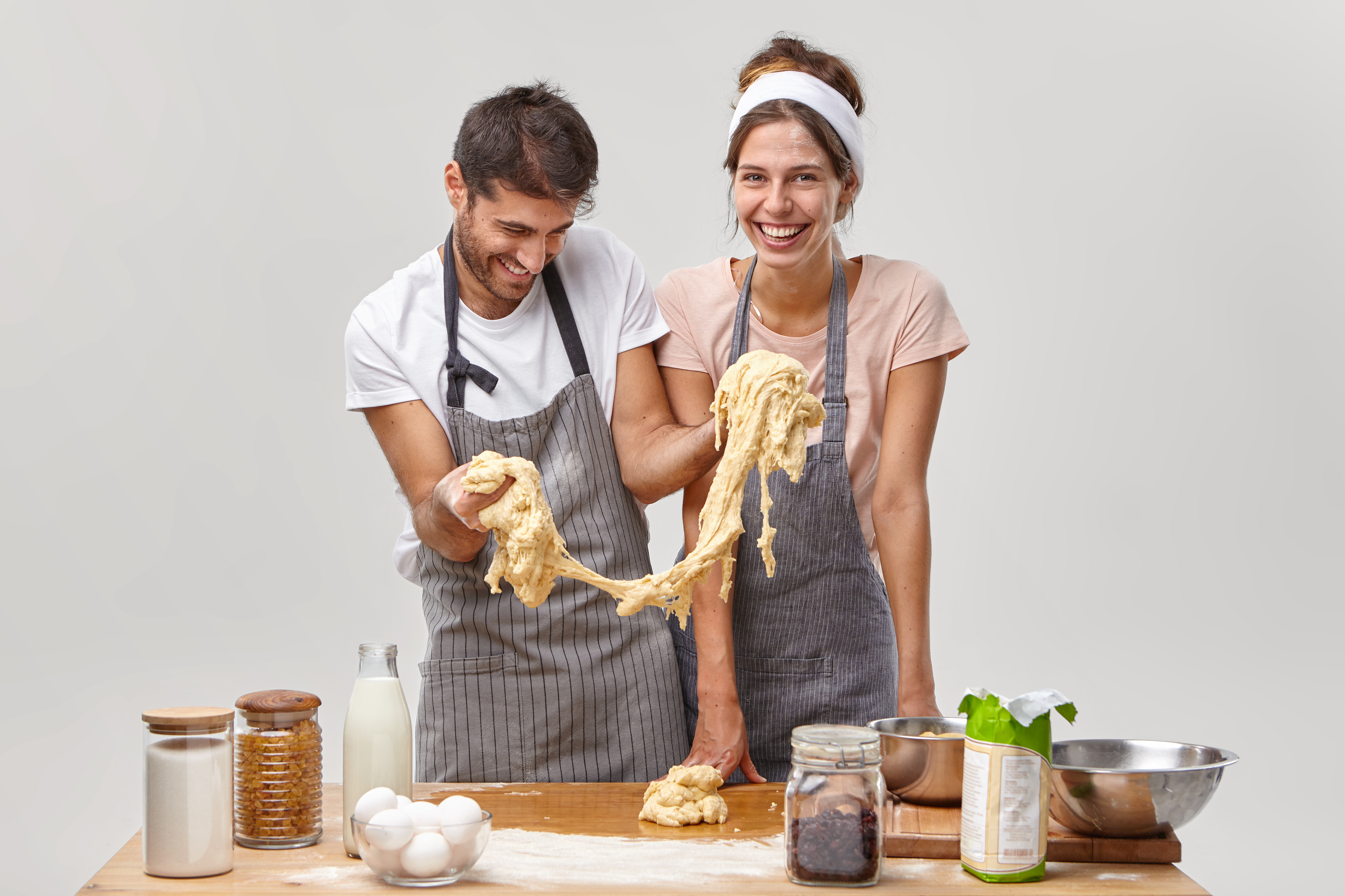 Young couple laughing while baking together in kitchen — authentic food content that audiences trust