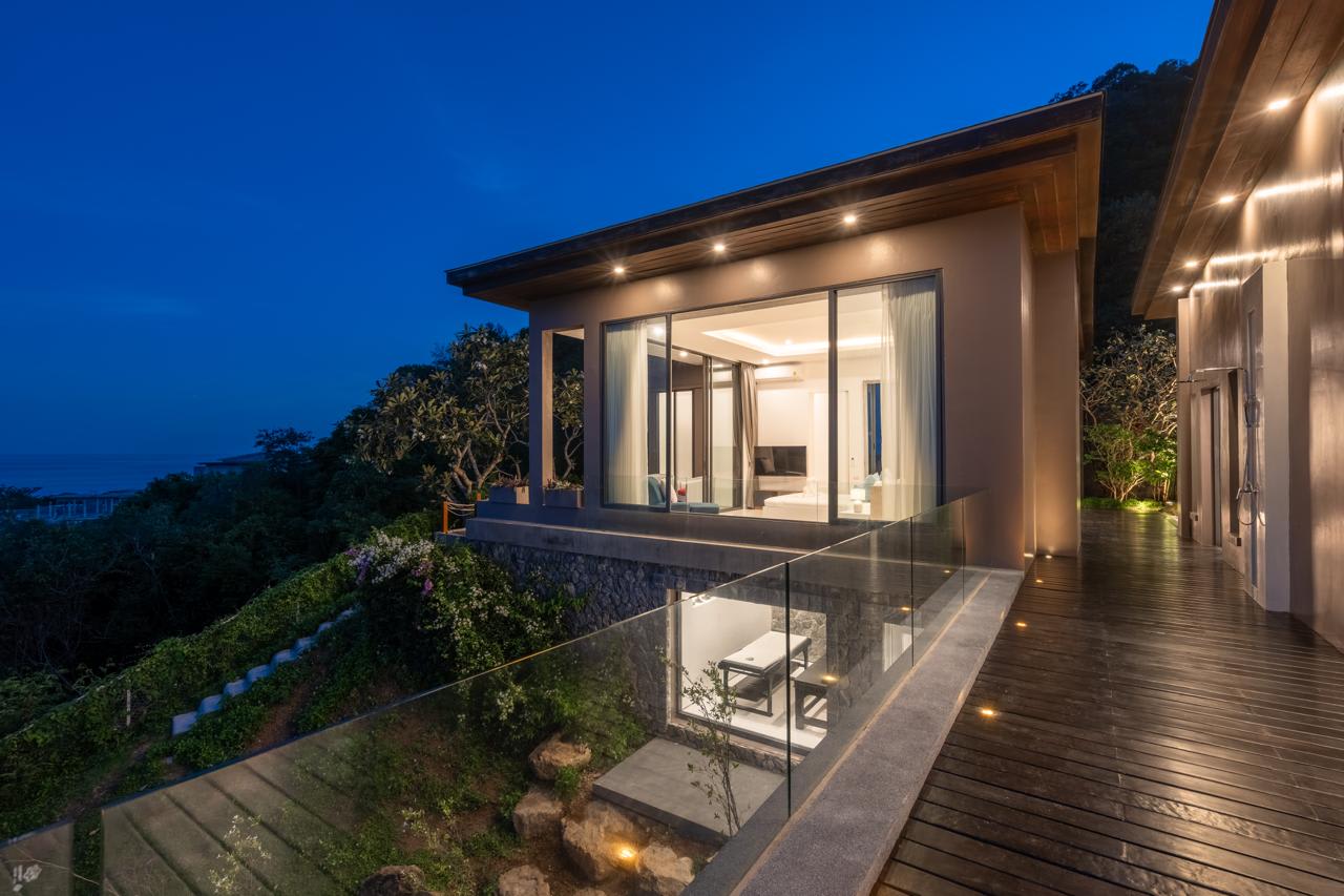 Modern sea-view villa at twilight, Koh Samui — glass-railed deck and infinity views