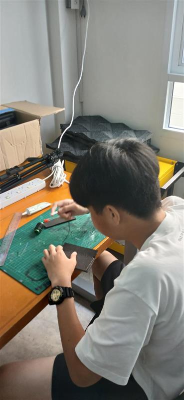 A 3D printer creating a complex yellow object.