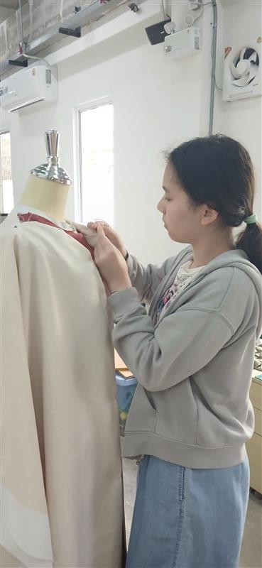 A student focused on an electronics project, integrating multiple skills.