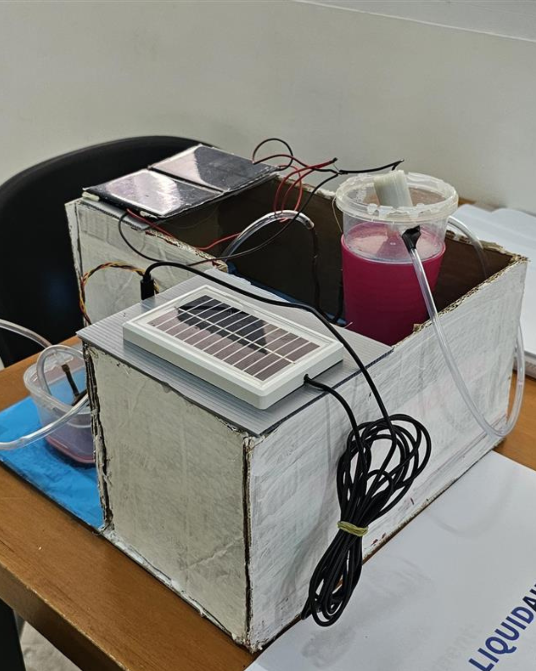 A student-built solar-powered prototype made from cardboard, tubing and a solar panel
