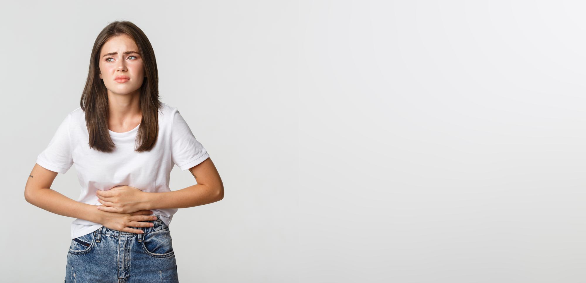 woman-having-stomach-ache-bending-holding-hands-belly-discomfort-from-menstrual-cramps