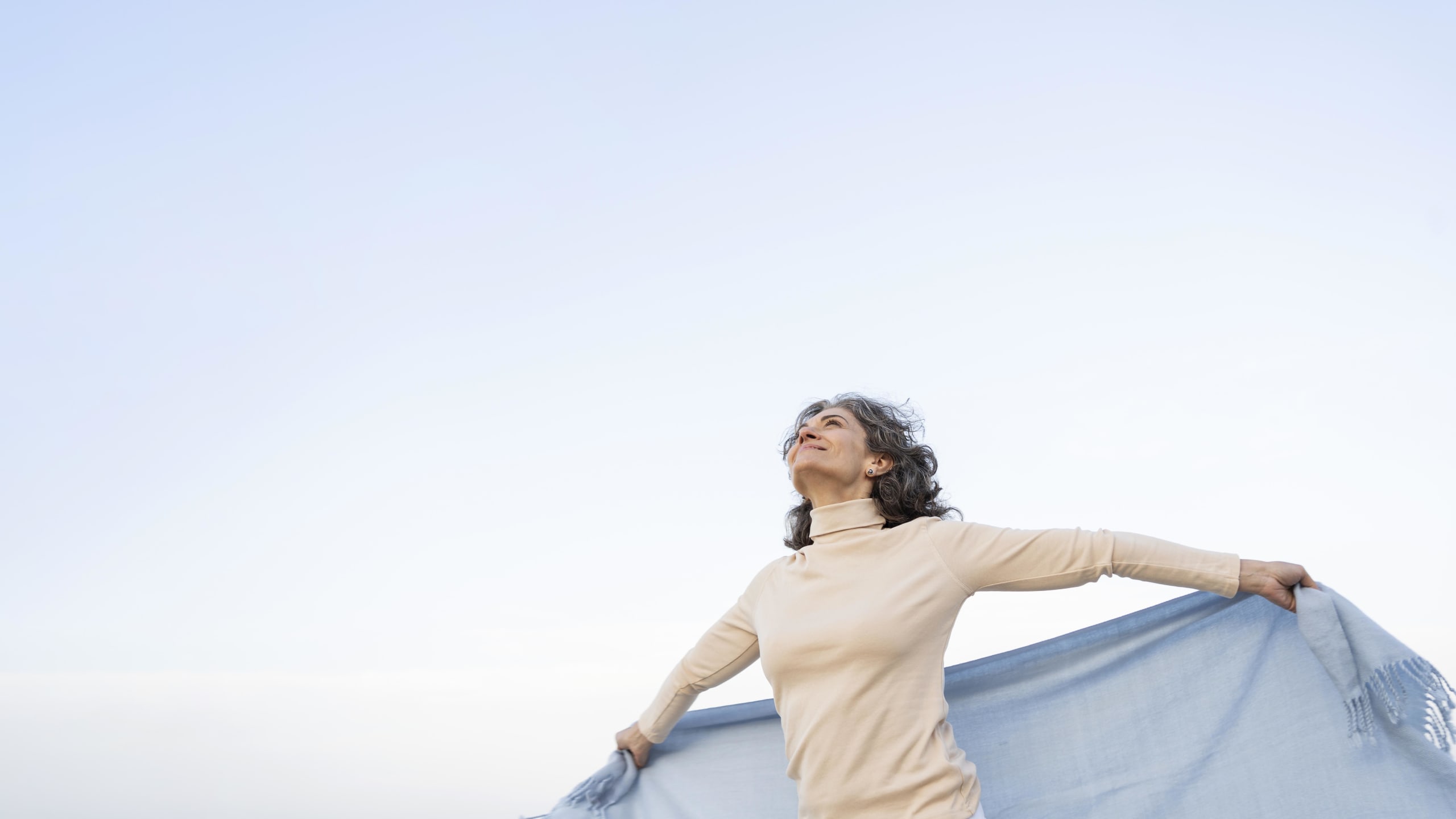 older-woman-enjoying-her-time-beach
