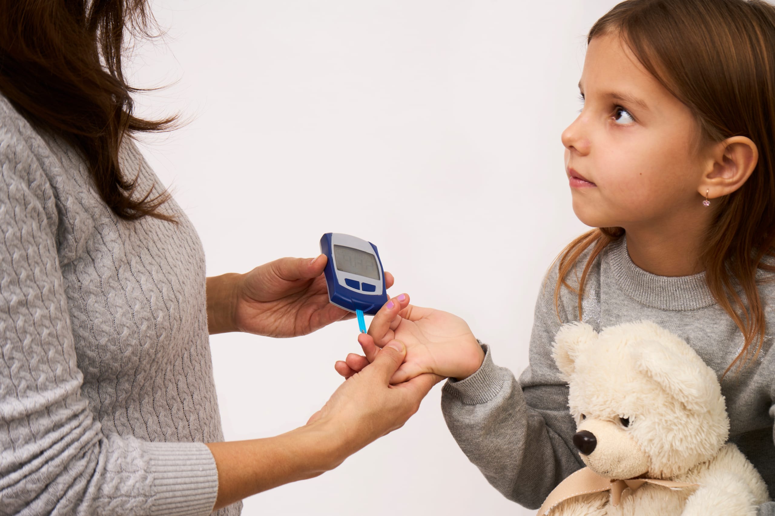 Woman checking diabetes to daughter girl Kid Diabetes