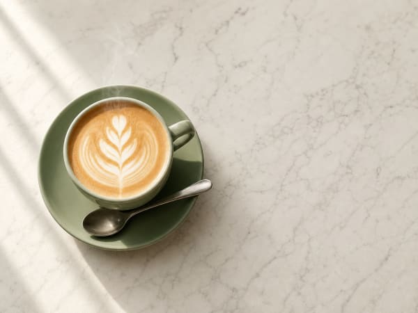 Close-up latte art — specialty espresso on a marble bench