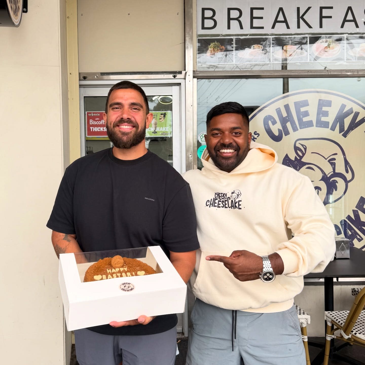 Owner with a customer in front of the Cheeky Cheesecake Newton storefront on Easter weekend.