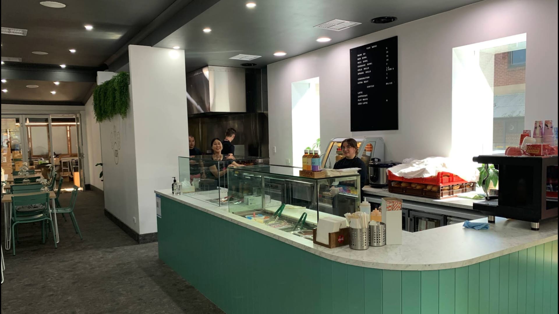 VDR counter interior with sage-green cabinetry and staff.