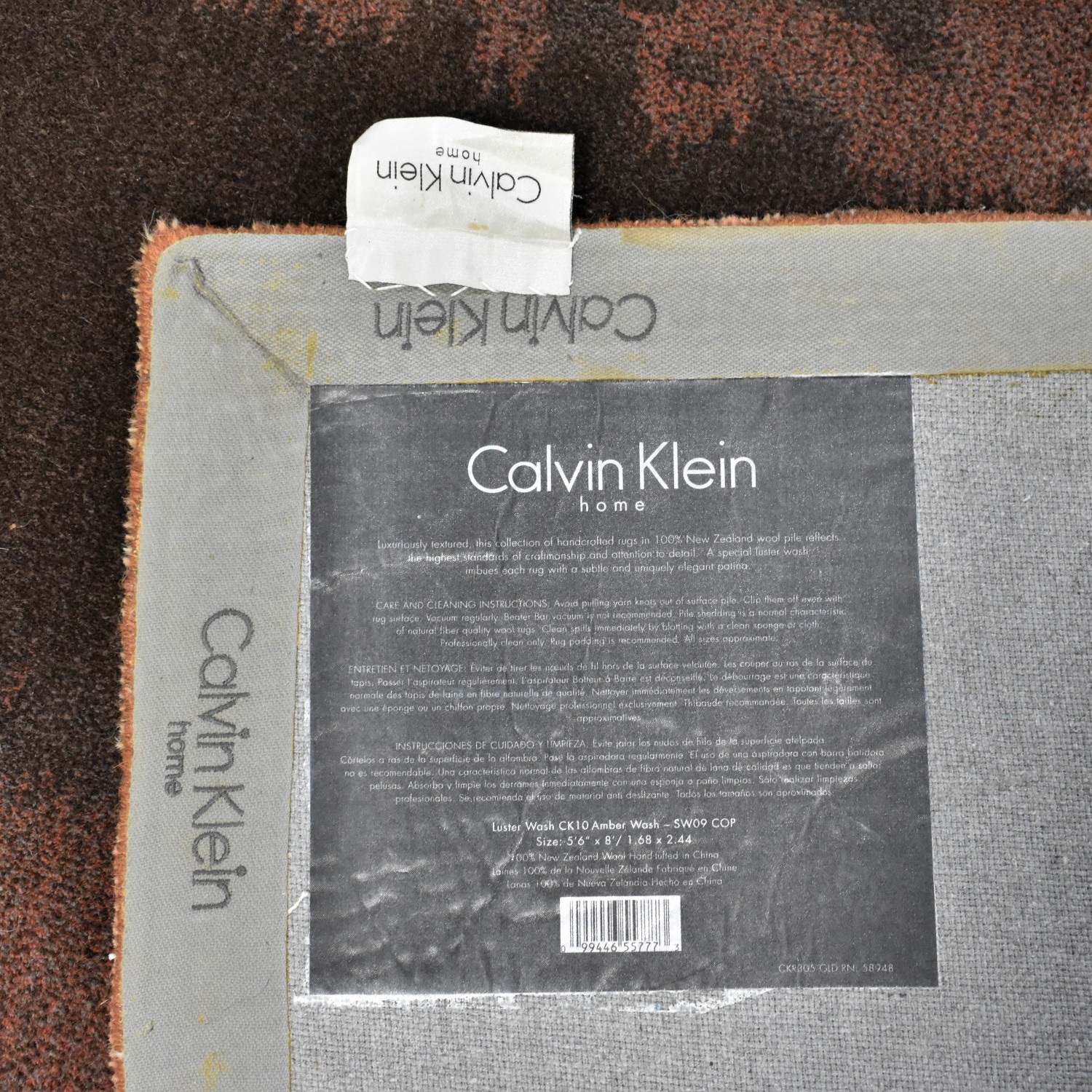 https://res.cloudinary.com/dkqtxtobb/image/upload/f_auto,q_auto:best,w_1500/product-assets/215085/calvin-klein/decor/rugs/calvin-klein-home-luster-wash-amber-wash-area-rug-used.jpeg