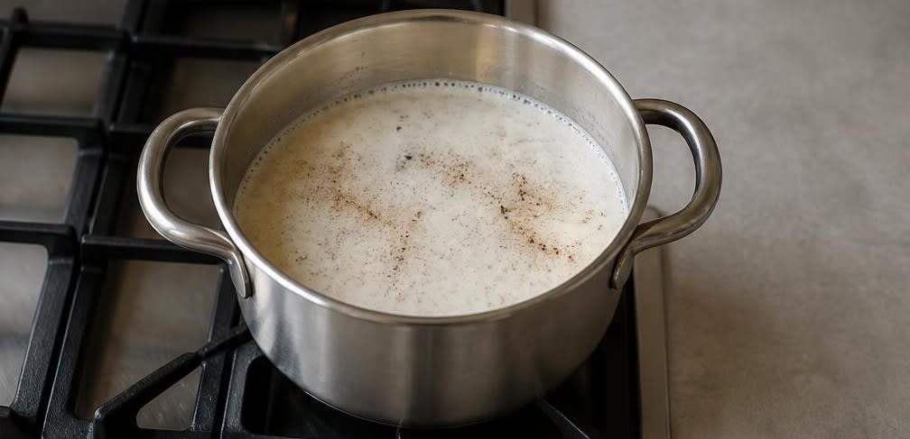 Warmes Hirse-Müsli mit Erdbeeren und gerösteten Sonnenblumenkernen – Zubereitung Schritt für Schritt – Milch mit Gewürzen erhitzen