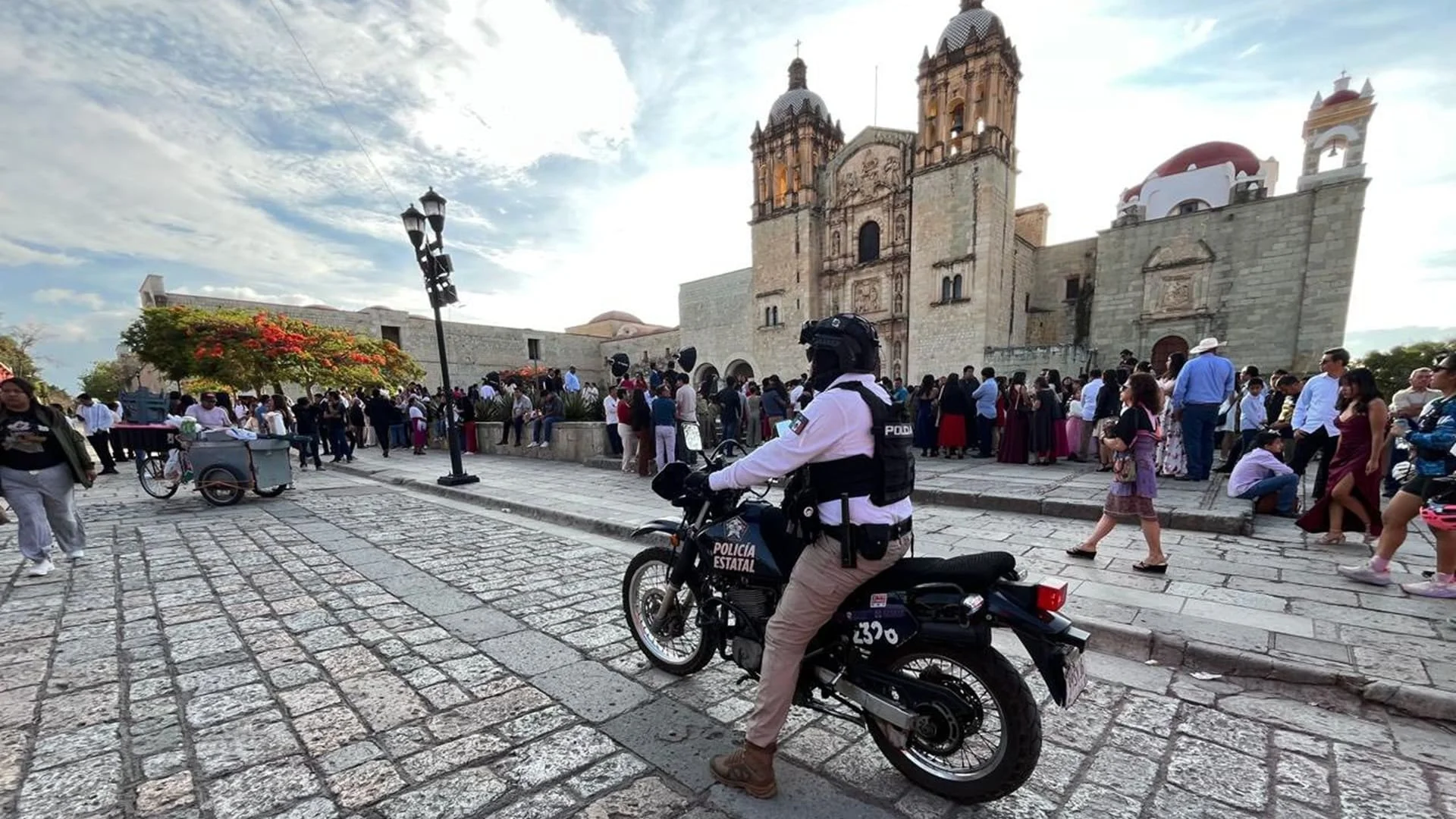 Police officer on motorcycle in front of Santo Domingo de Guzmán Temple, Oaxaca
