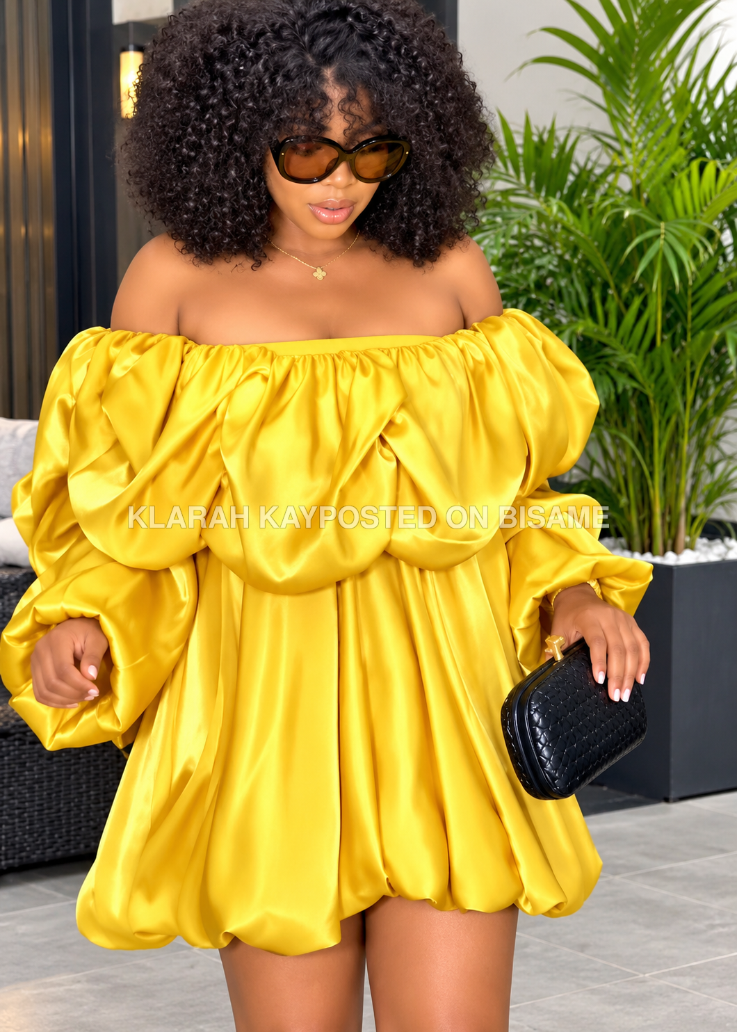 luxurious yellow off-the-shoulder satin dress.