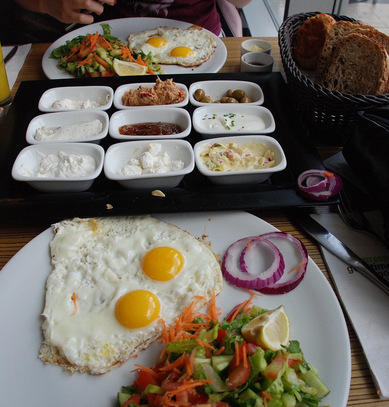 Israeli Breakfast (Eggs, Chopped Salad, Soft Cheeses, Tahini and Bread)