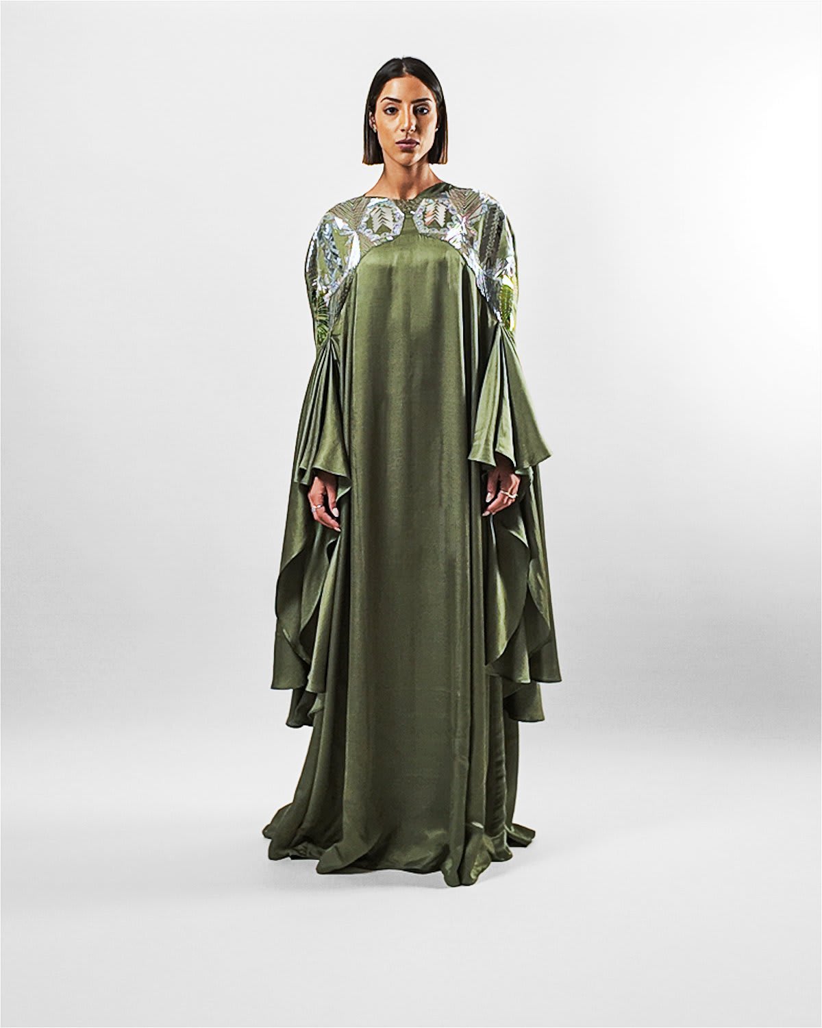 ecuca kaftan Tanisha Rada model wearing the Ecuca Kaftan in Olive Green Eucalyptus Fabric, featuring statement sleeves and embellished neckline. Front view.