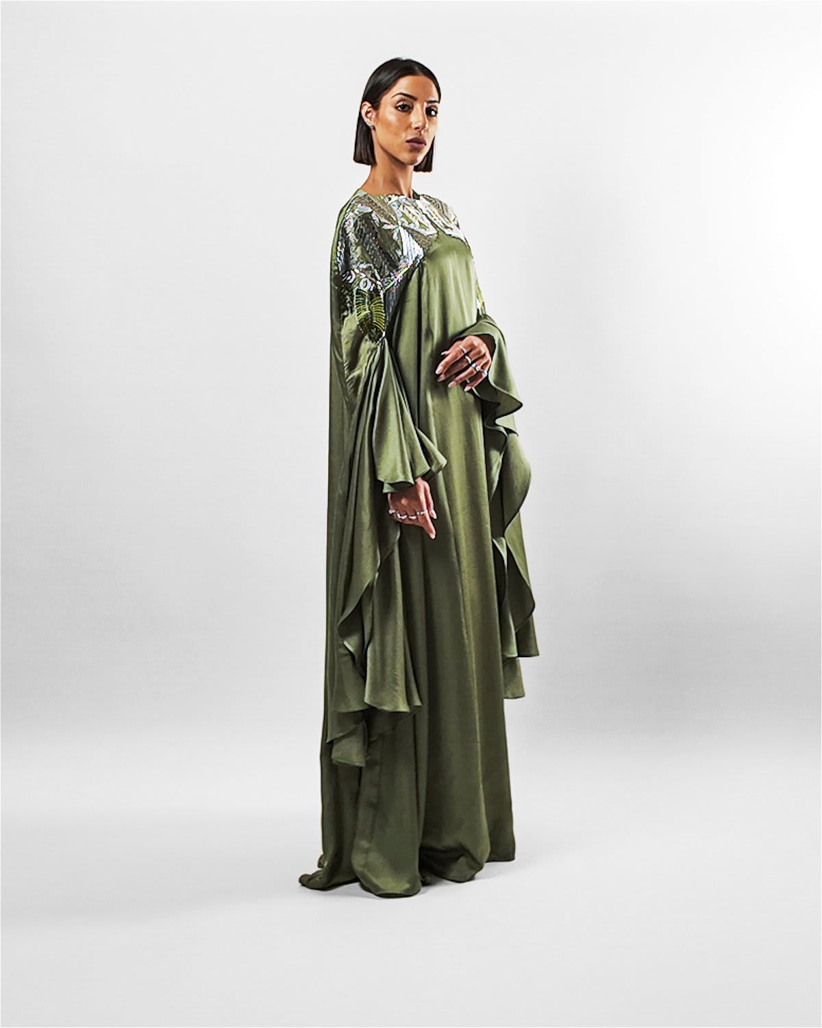 ecuca kaftan Tanisha Rada model wearing the Ecuca Kaftan in Olive Green Eucalyptus Fabric, featuring statement sleeves and embellished neckline. side view.