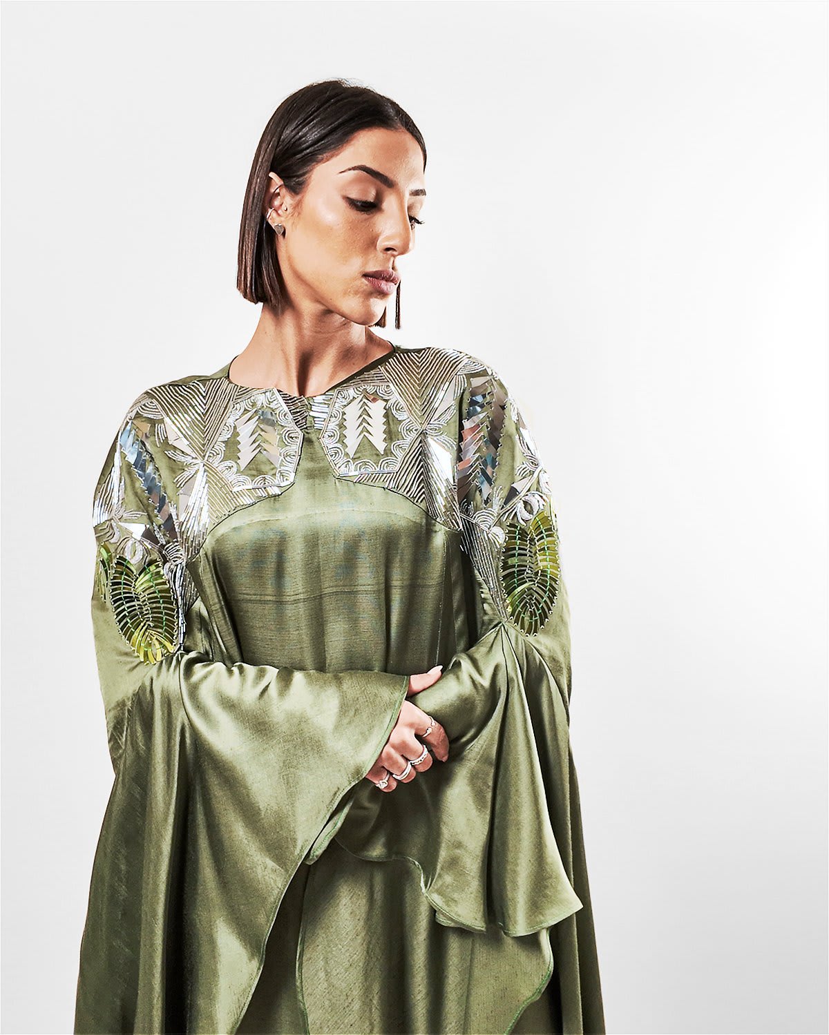 ecuca kaftan Tanisha Rada model wearing the Ecuca Kaftan in Olive Green Eucalyptus Fabric, featuring statement sleeves and embellished neckline. close up view.