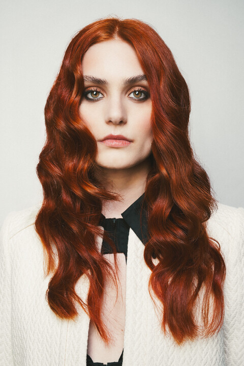 a model with long copper hair