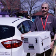 John carries box to car