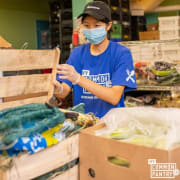 Volunteer UNpacking Produce