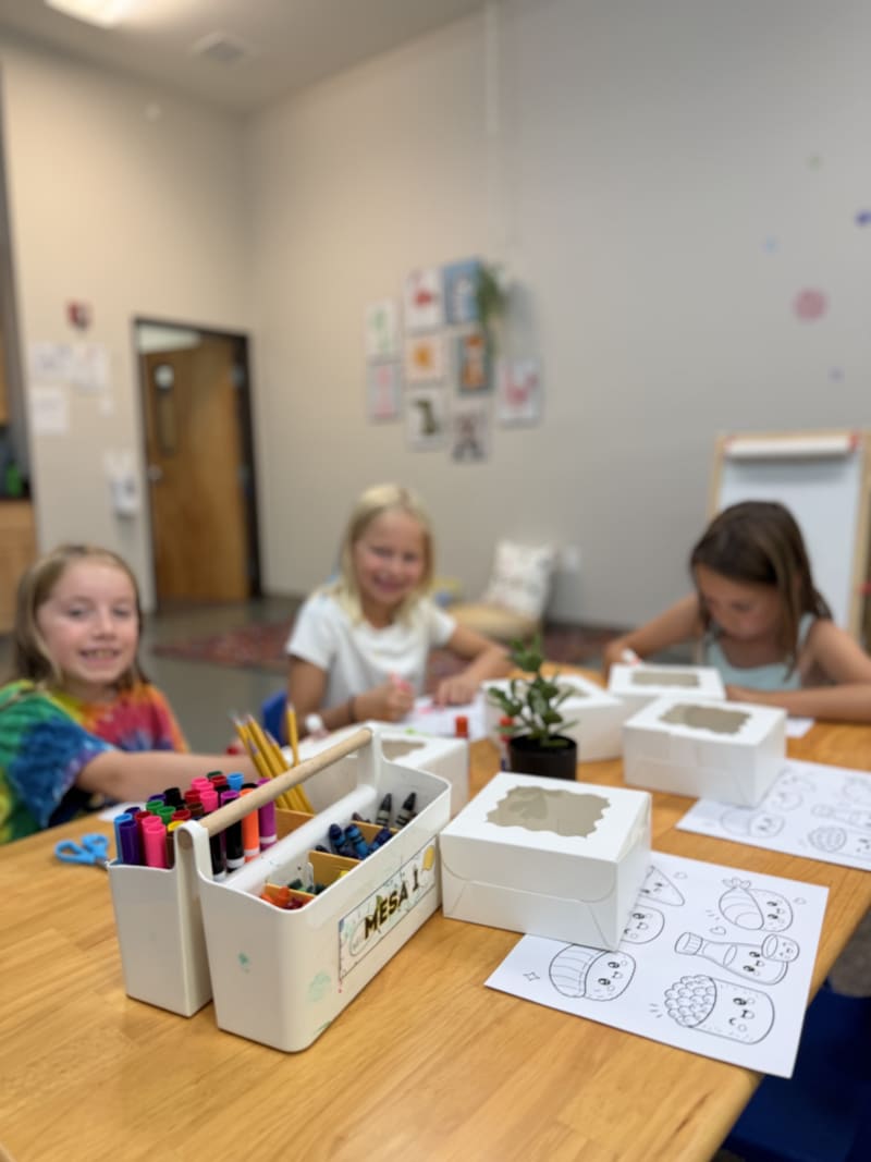 Students coloring and drawing together at the art table
