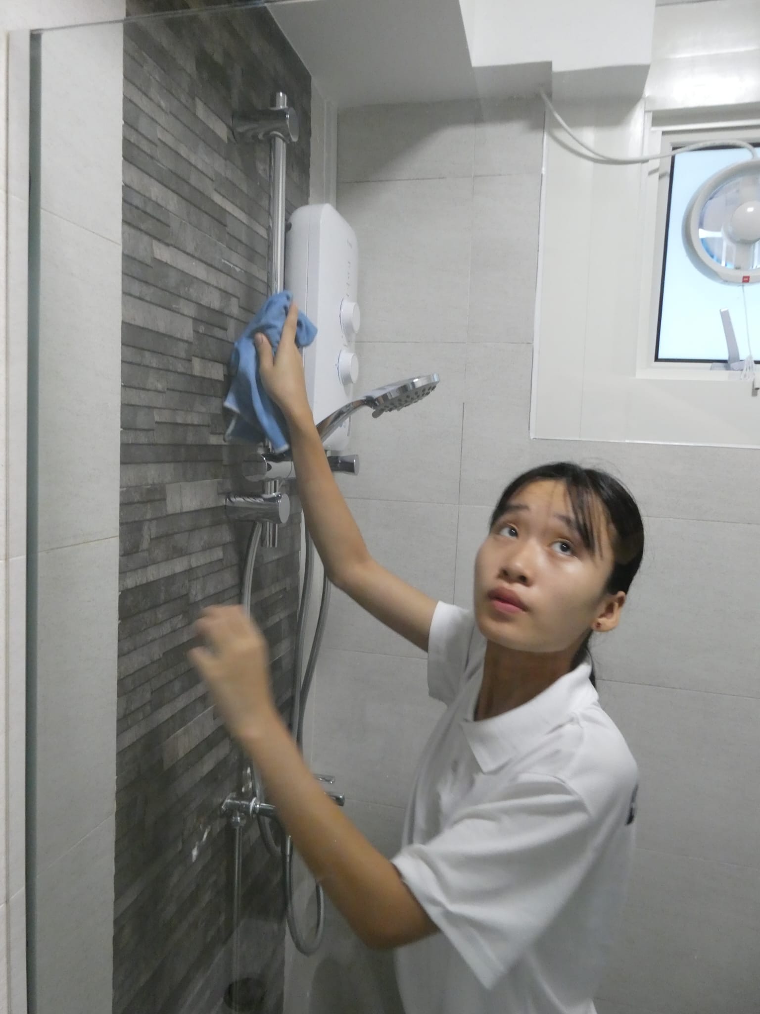 ASC cleaner scrubbing bathroom in Singapore home