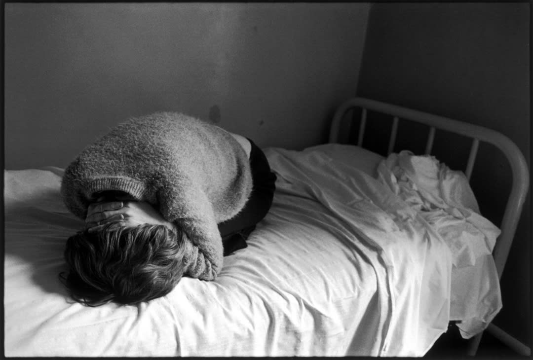 Mary Iris in bed, Ward 81, Oregon State Hospital, Salem, Oregon, 1976