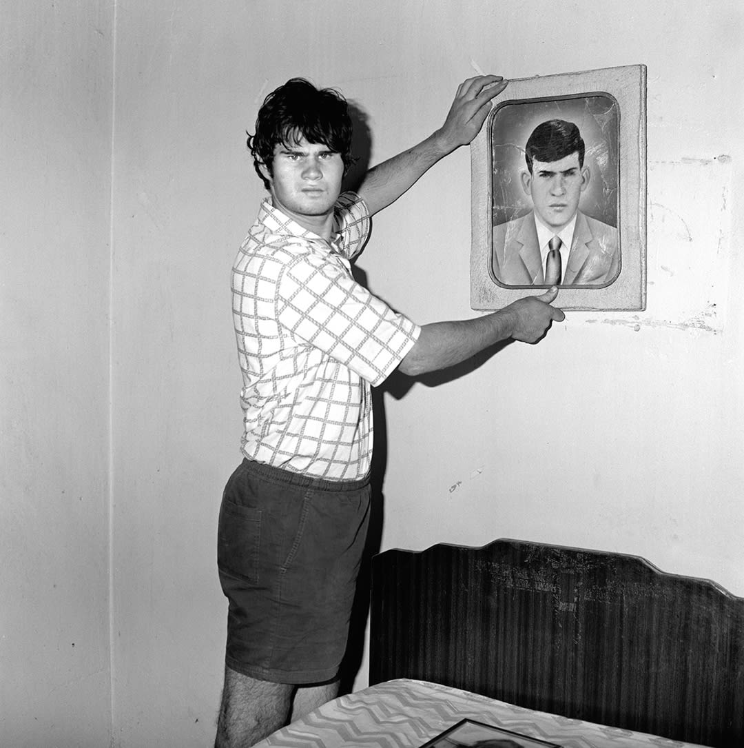 Factory Worker Holding Portrait of Grandfather, 1996