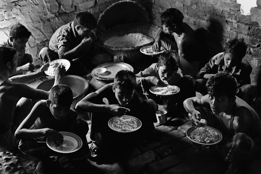 At brickfields, workers eat low-quality meals of rice and vegetables. Bakkar brickfield, Chittagong, Bangladesh, 2013.