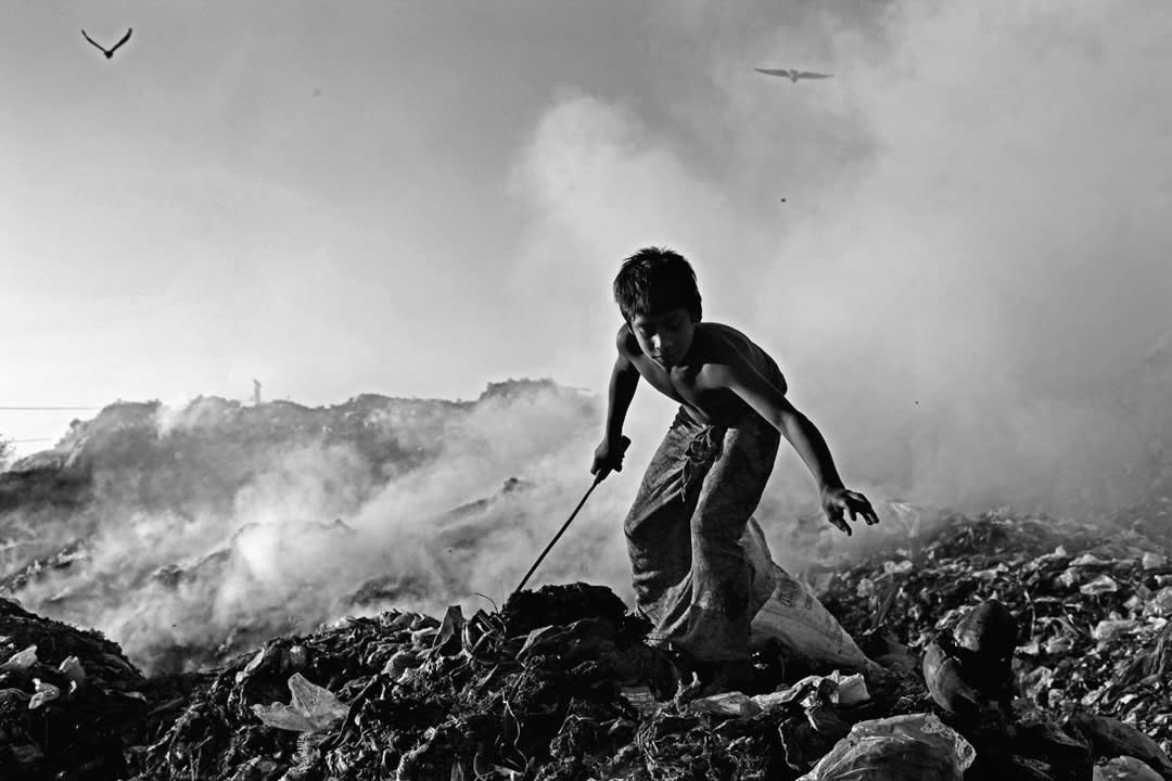 At Anandabazar dump yard, hundreds of child laborers and their families work day and night to survive. Chittagong, Banglad...