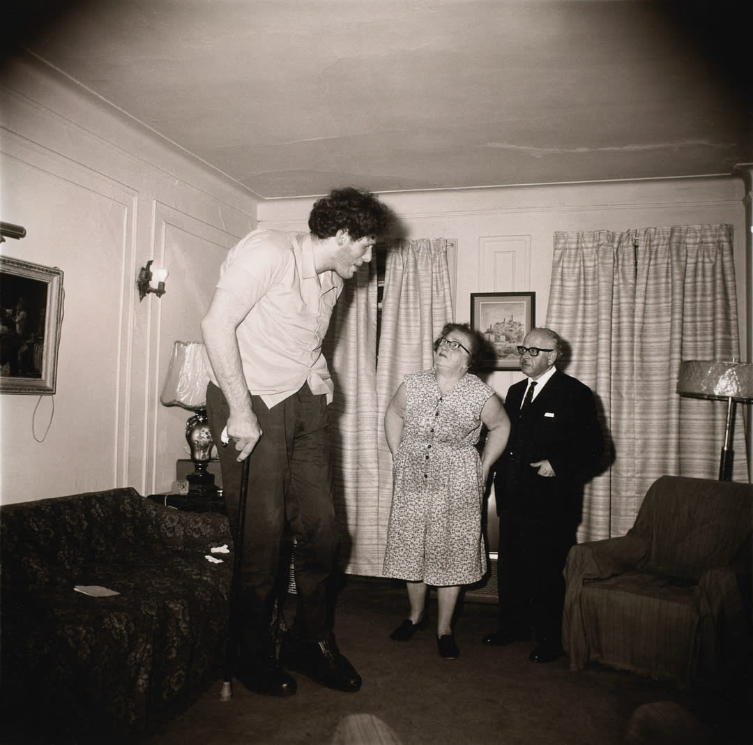 A Jewish giant at home with his parents in the Bronx, N.Y. 1970