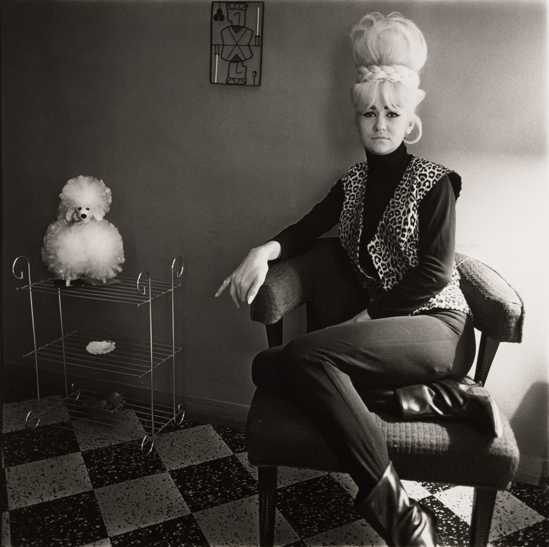 Lady bartender at home with a souvenir dog, New Orleans, La. 1964
