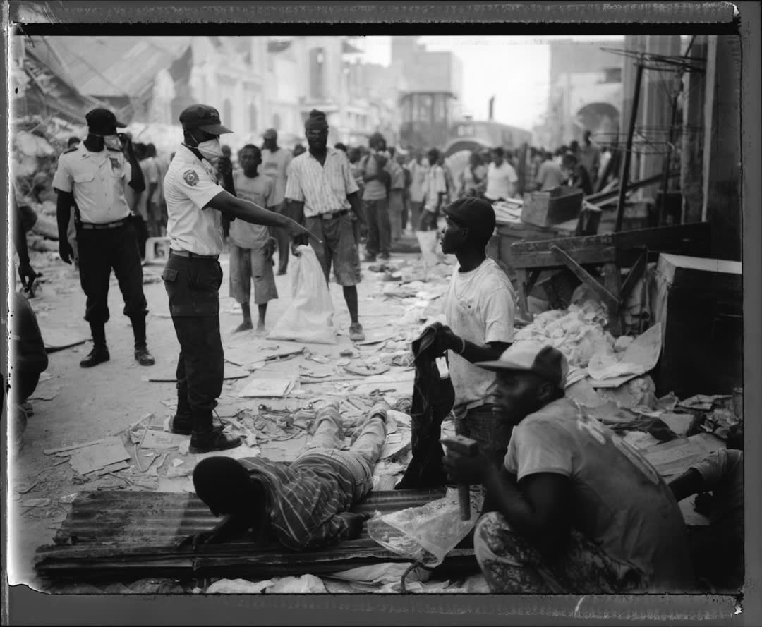 Haitian National Police gather a group of "looters" or "salvagers" and confront them. In some of these instances the loote...