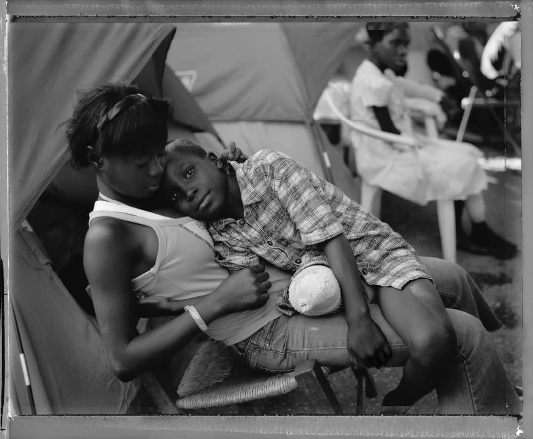 A sister holds her younger brother after his right leg was amputated at the Adventist Hospital in Port au Prince, Haiti.